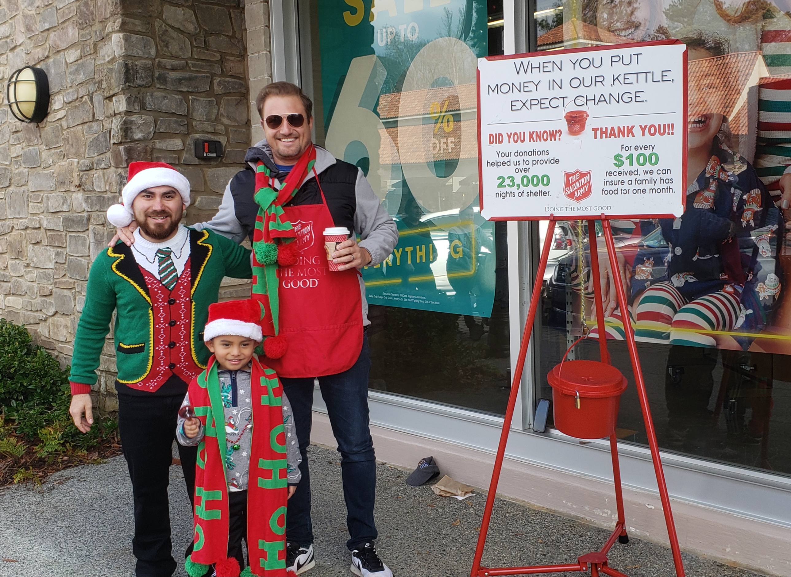 Members of our senior staff and their families ringing bells for the Salvation Army